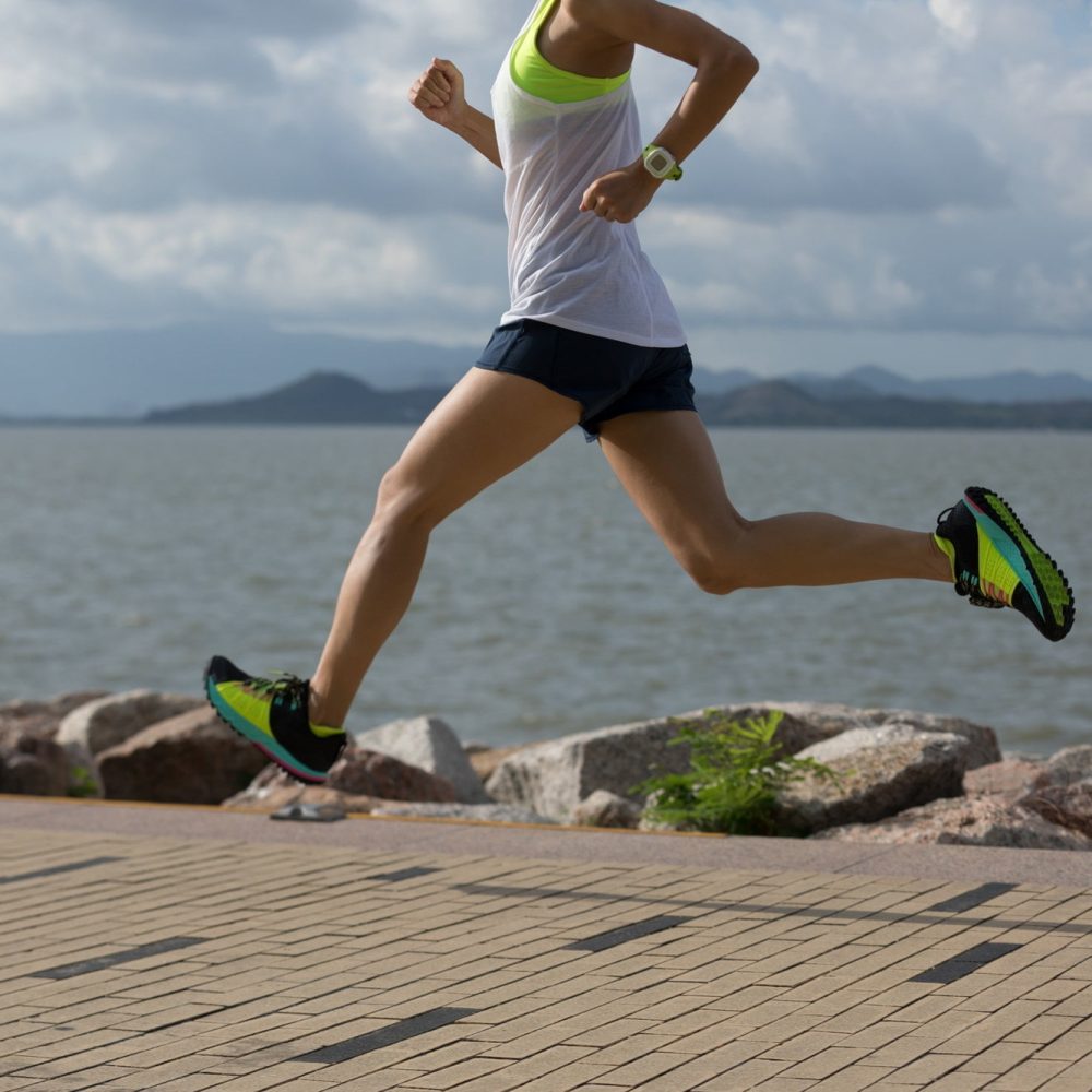 runner training for marathon running at seaside