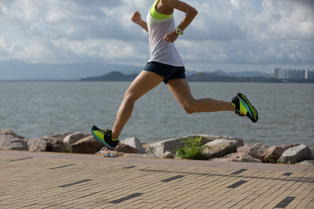 runner training for marathon running at seaside